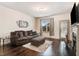 Bright living room with hardwood floors, decorative painting, and a cozy fireplace at 51 Balboa Pkwy, Clayton, NC 27520