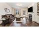 Cozy living room featuring a fireplace, large window, and hardwood floors at 51 Balboa Pkwy, Clayton, NC 27520