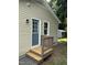 Back entrance features a small porch and blue door with window lights at 510 North St, Graham, NC 27253