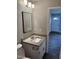 Bathroom with granite countertop, modern mirror, and new flooring, next to the toilet and shower at 510 North St, Graham, NC 27253