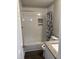 Recently updated bathroom with a modern shower and glass door adjacent to the toilet and sink at 510 North St, Graham, NC 27253