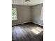 Empty bedroom featuring new flooring and paint, with two windows providing ample natural light at 510 North St, Graham, NC 27253