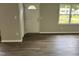 The entryway offers wood flooring, neutral walls, and natural light from the window at 510 North St, Graham, NC 27253