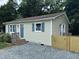 Corner view of a single-story home with a gravel driveway and newly constructed wooden fence at 510 North St, Graham, NC 27253