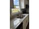 Granite counters and stainless steel sink in kitchen filled with natural light coming through the window at 510 North St, Graham, NC 27253