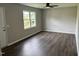 Bright living room showcasing wood flooring, fresh paint, and large window with natural light at 510 North St, Graham, NC 27253