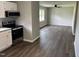 View from the kitchen showing the open floor plan into the freshly painted and floored living room at 510 North St, Graham, NC 27253