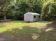 Backyard storage shed offering ample storage space with a ramped entryway at 510 North St, Graham, NC 27253