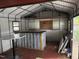 Storage shed interior featuring metal walls and ceiling with a small serving area at 510 North St, Graham, NC 27253