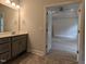 Bathroom view with gray vanity, modern lighting, and entryway to bedroom with tray ceiling at 511 Sweet Potato Lane # 10, Nashville, NC 27856