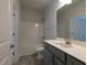 Bright bathroom featuring a shower-tub combo, gray vanity, and modern fixtures at 511 Sweet Potato Lane # 10, Nashville, NC 27856