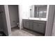 Bathroom featuring double vanity with grey cabinetry, chrome hardware and a framed mirror at 511 Sweet Potato Lane # 10, Nashville, NC 27856