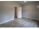 Bedroom with wire shelving in closet, wood-look floors, and neutral wall paint at 511 Sweet Potato Lane # 10, Nashville, NC 27856