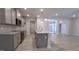 Open concept kitchen boasting an island, granite counters, gray cabinets and stainless appliances at 511 Sweet Potato Lane # 10, Nashville, NC 27856