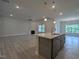 Open-concept kitchen with granite countertops, stainless steel appliances, and gray cabinets at 511 Sweet Potato Lane # 10, Nashville, NC 27856