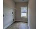 Functional laundry room featuring tile flooring and a window for natural light at 511 Sweet Potato Lane # 10, Nashville, NC 27856