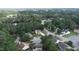 Aerial view of a neighborhood with mature trees, well-maintained lawns and various home styles at 5200 Fieldwood Ct, Raleigh, NC 27616