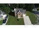 Aerial view of a charming two-story home with a driveway and well-manicured lawn at 5200 Fieldwood Ct, Raleigh, NC 27616