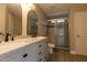 Bathroom with a double sink vanity, a large mirror and a glass enclosed shower at 5200 Fieldwood Ct, Raleigh, NC 27616