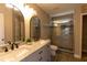 Bathroom with a double sink vanity, a large mirror and a glass enclosed shower at 5200 Fieldwood Ct, Raleigh, NC 27616