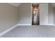 Bedroom with neutral walls, carpet flooring, and a doorway to the hallway with hardwood floors at 5200 Fieldwood Ct, Raleigh, NC 27616