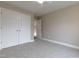 Bedroom with neutral walls, carpet floor, closet and open doorway to the next room at 5200 Fieldwood Ct, Raleigh, NC 27616