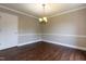 Cozy dining room with wood floors and neutral paint with a modern light fixture at 5200 Fieldwood Ct, Raleigh, NC 27616