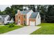 Charming two-story home with brick and siding, an attached garage, and a spacious driveway at 5200 Fieldwood Ct, Raleigh, NC 27616
