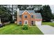 Charming two-story brick home with teal shutters and a well-manicured lawn at 5200 Fieldwood Ct, Raleigh, NC 27616