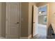 Hallway view of bedroom with ceiling fan and window, showing neutral paint and flooring at 5200 Fieldwood Ct, Raleigh, NC 27616