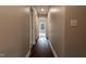 Long hallway with wood-look flooring leads to a carpeted room and other parts of the home at 5200 Fieldwood Ct, Raleigh, NC 27616