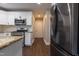Bright kitchen features white cabinets, granite counters, and stainless steel appliances at 5200 Fieldwood Ct, Raleigh, NC 27616