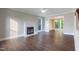 View of the living room with wood floors, a fireplace, and plenty of natural light at 5200 Fieldwood Ct, Raleigh, NC 27616
