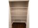 A well-lit pantry features wire shelving and wood look flooring at 5200 Fieldwood Ct, Raleigh, NC 27616