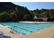 A beautiful community pool with clear blue water, surrounded by trees and comfortable lounge chairs at 5200 Fieldwood Ct, Raleigh, NC 27616