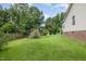 Fenced backyard featuring an expansive lawn and mature trees for privacy at 559 Blue Pond Rd, Clayton, NC 27520