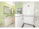 Bright bathroom featuring double sink vanity, glass enclosed shower and subway tile walls at 559 Blue Pond Rd, Clayton, NC 27520