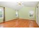 Spacious bedroom with hardwood floors, bright green walls and lots of natural light at 559 Blue Pond Rd, Clayton, NC 27520