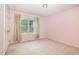 This bedroom features a window with natural light and charming floral curtains at 559 Blue Pond Rd, Clayton, NC 27520