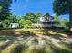 Expansive backyard featuring a two-story home, lush greenery, and a detached garage or shed at 5760 Hesters Store Rd, Hurdle Mills, NC 27541