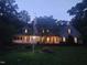 Charming two-story home with a wraparound porch and a well-manicured front yard at dusk at 5760 Hesters Store Rd, Hurdle Mills, NC 27541
