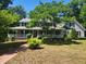 Charming two-story home with a welcoming front porch and mature landscaping in a lush yard at 5760 Hesters Store Rd, Hurdle Mills, NC 27541