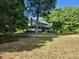 Beautiful two-story home with a covered porch surrounded by mature trees and a spacious front yard at 5760 Hesters Store Rd, Hurdle Mills, NC 27541