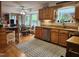 Kitchen featuring wood cabinets, a stainless steel dishwasher, breakfast nook and large windows overlooking backyard at 5760 Hesters Store Rd, Hurdle Mills, NC 27541