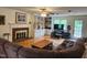 Comfortable living room with a fireplace, built-in shelving, and a neutral color palette at 5760 Hesters Store Rd, Hurdle Mills, NC 27541