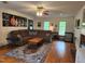 Inviting living room with hardwood floors, fireplace, and ample natural light from multiple windows at 5760 Hesters Store Rd, Hurdle Mills, NC 27541