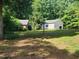 Property featuring multiple outbuildings or sheds surrounded by a spacious, well-maintained lawn at 5760 Hesters Store Rd, Hurdle Mills, NC 27541