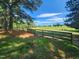 Wide open green pasture enclosed by a wooden fence, perfect for horses or livestock at 5760 Hesters Store Rd, Hurdle Mills, NC 27541
