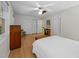 Sunlit bedroom featuring wood floors, triple closet doors, and classic vintage decor at 6021 Dixon Dr, Raleigh, NC 27609