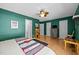 Spacious bedroom with bamboo floors, ceiling fan, and ensuite bathroom offers ample natural light at 6021 Dixon Dr, Raleigh, NC 27609